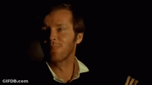 A Close Up Of A Man 'S Face In A Dark Room With A Black Background . GIF