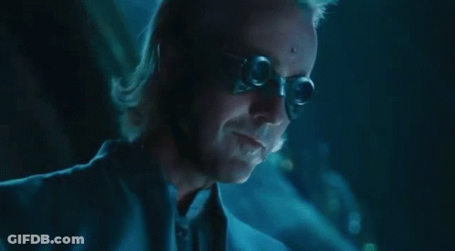 A Close Up Of A Man 'S Face In A Dark Room With A Blue Background . GIF