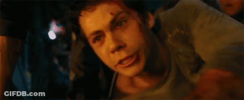 A Close Up Of A Man 'S Face In A Dark Room With A Blurred Background . GIF
