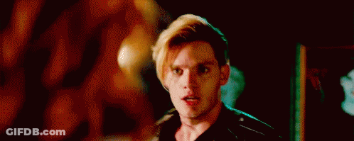 A Close Up Of A Man 'S Face In A Dark Room With A Blurred Background . GIF