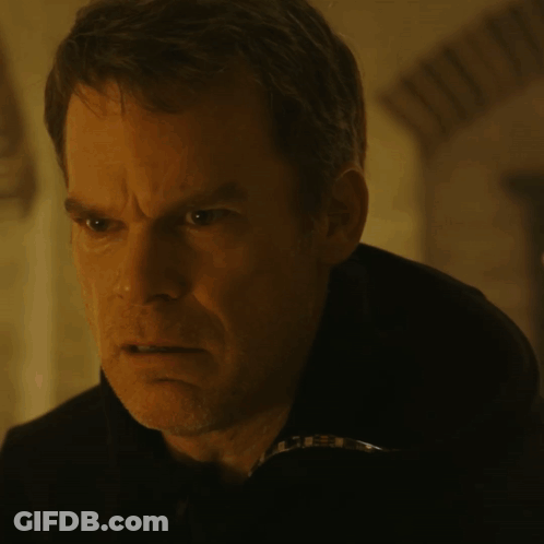 A Close Up Of A Man 'S Face In A Dark Room With A Blurry Background GIF