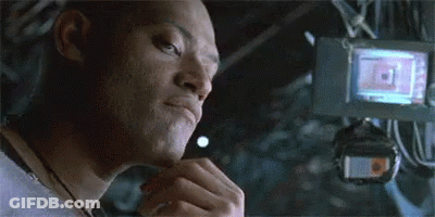 A Close Up Of A Man 'S Face In A Dark Room With A Camera In The Background . GIF