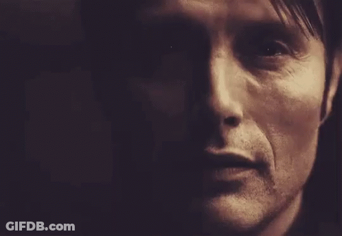 A Close Up Of A Man 'S Face In A Dark Room With A Dark Background . GIF