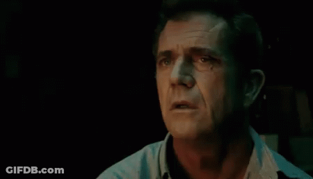 A Close Up Of A Man 'S Face In A Dark Room With His Eyes Closed And His Mouth Open . GIF