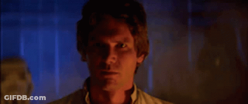 A Close Up Of A Man 'S Face In A Dark Room With Smoke Coming Out Of His Eyes . GIF