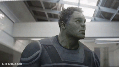 A Close Up Of A Man 'S Face In A Gray Suit GIF