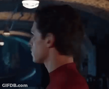 A Close Up Of A Man 'S Face In A Red Spiderman Suit . GIF