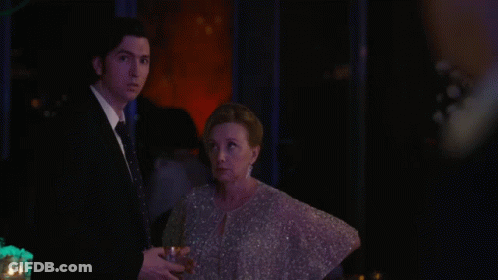 A Close Up Of A Man 'S Face In A Suit And Tie GIF