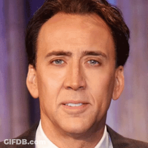 A Close Up Of A Man 'S Face In A Suit And Tie GIF