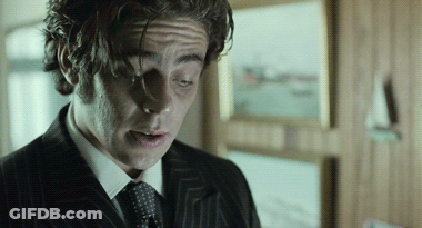 A Close Up Of A Man 'S Face In A Suit And Tie GIF