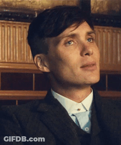 A Close Up Of A Man 'S Face In A Suit And Tie GIF