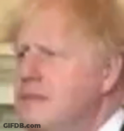 A Close Up Of A Man 'S Face In A Suit And Tie With A Serious Look On His Face . GIF