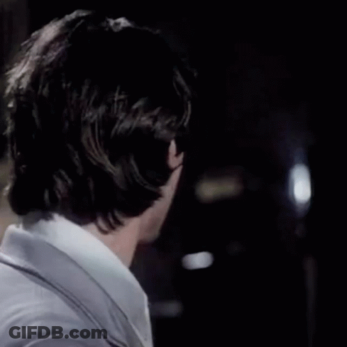 A Close Up Of A Man 'S Face In A Suit And Tie With His Eyes Closed . GIF