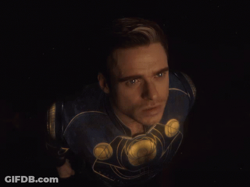 A Close Up Of A Man 'S Face In A Superhero Costume GIF
