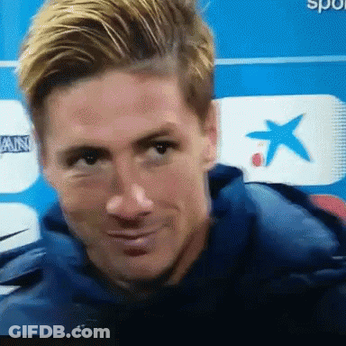 A Close Up Of A Man 'S Face In Front Of A Blue Background GIF