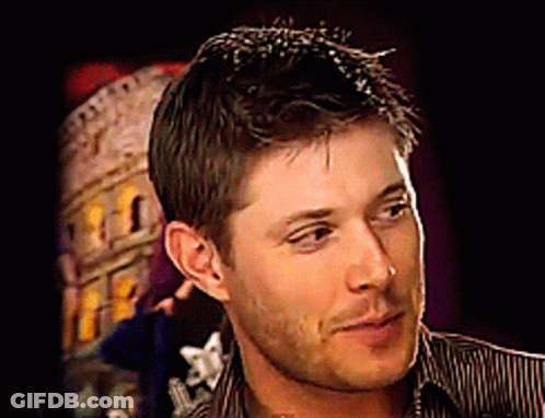 A Close Up Of A Man 'S Face In Front Of A Building GIF