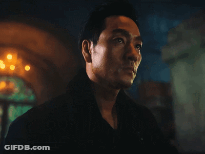 A Close Up Of A Man 'S Face In Front Of A Fire GIF
