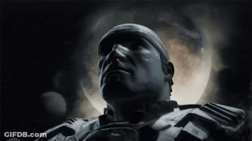 A Close Up Of A Man 'S Face In Front Of A Full Moon In A Dark Room . GIF