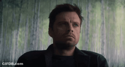A Close Up Of A Man 'S Face In Front Of A Green Wall GIF