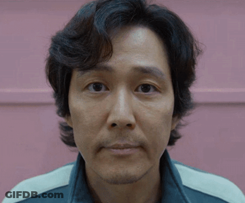 A Close Up Of A Man 'S Face In Front Of A Pink Wall GIF