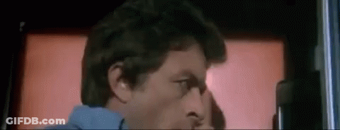 A Close Up Of A Man 'S Face In Front Of A Red Background . GIF
