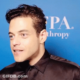 A Close Up Of A Man 'S Face In Front Of A Sign That Says Pa Thropy GIF