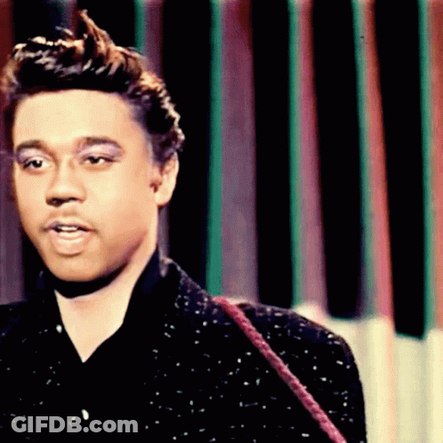 A Close Up Of A Man 'S Face In Front Of A Striped Background GIF