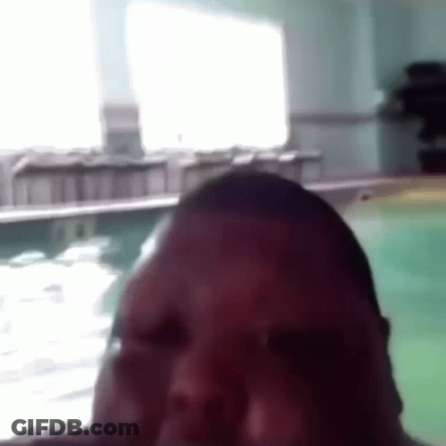 A Close Up Of A Man 'S Face In Front Of A Swimming Pool . GIF