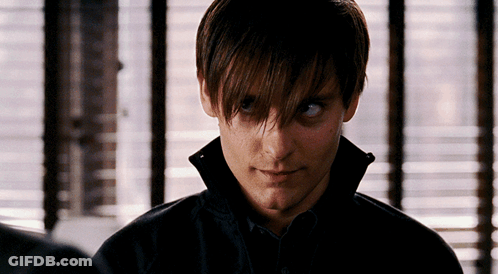 A Close Up Of A Man 'S Face In Front Of A Window With Blinds GIF