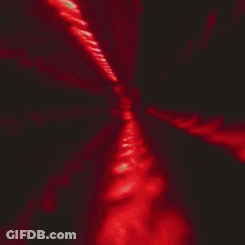 A Close Up Of A Man 'S Face In Red Light GIF