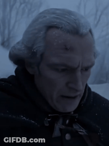 A Close Up Of A Man 'S Face In The Dark GIF