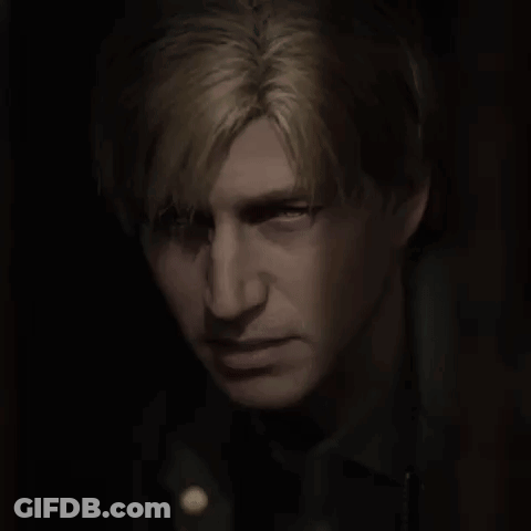A Close Up Of A Man 'S Face In The Dark GIF