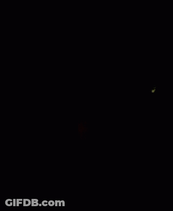 A Close Up Of A Man 'S Face In The Dark GIF