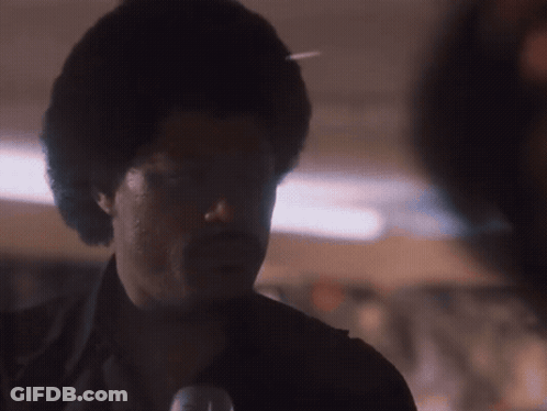 A Close Up Of A Man 'S Face In The Dark GIF