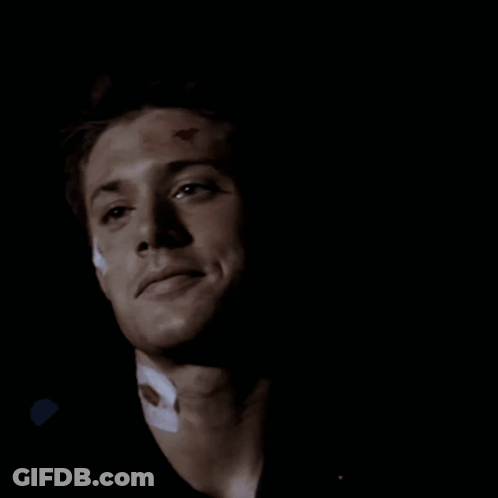 A Close Up Of A Man 'S Face In The Dark GIF
