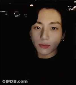 A Close Up Of A Man 'S Face In The Dark GIF