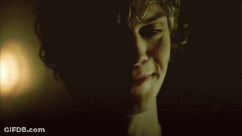 A Close Up Of A Man 'S Face In The Dark GIF