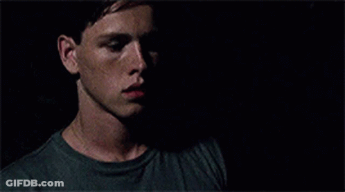 A Close Up Of A Man 'S Face In The Dark With A Shadow On His Face . GIF