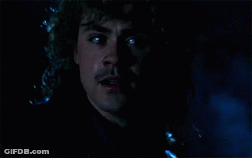 A Close Up Of A Man 'S Face In The Dark With Tears Coming Out Of His Eyes . GIF