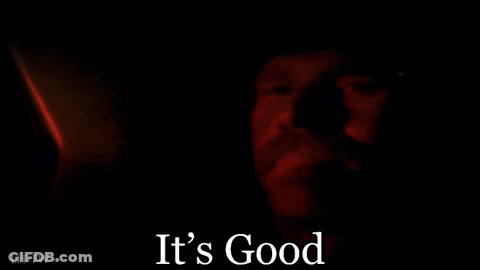 A Close Up Of A Man 'S Face In The Dark With The Words `` It 'S Good '' Written Below It . GIF
