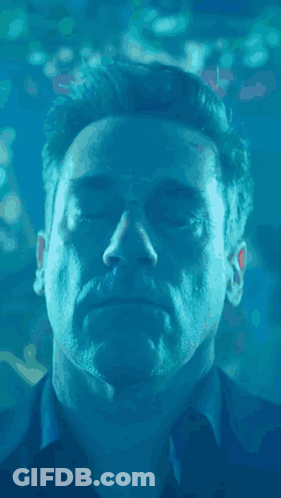 A Close Up Of A Man 'S Face In The Water With His Eyes Closed GIF