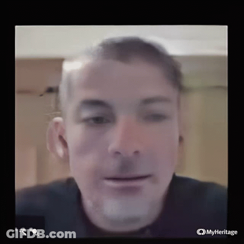 A Close Up Of A Man 'S Face Is Displayed On A Screen With Myheritage Written On The Bottom GIF
