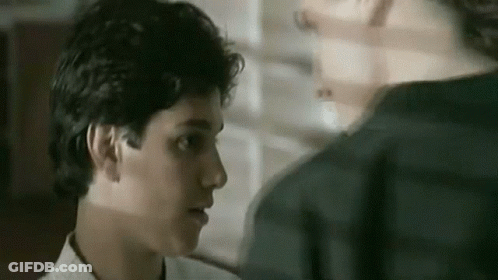 A Close Up Of A Man 'S Face Looking At Another Man 'S Face . GIF