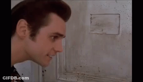 A Close Up Of A Man 'S Face Looking At The Camera . GIF