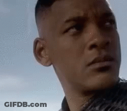 A Close Up Of A Man 'S Face Looking At The Camera . GIF