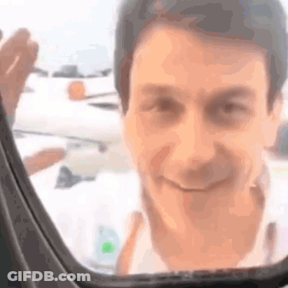 A Close Up Of A Man 'S Face Looking Out Of A Car Window . GIF
