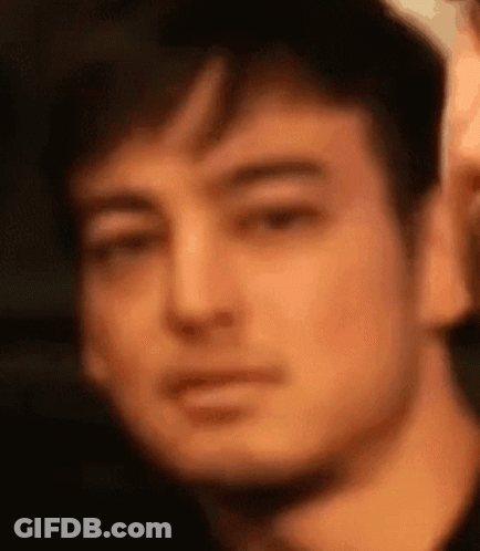 A Close Up Of A Man 'S Face Making A Funny Face . GIF