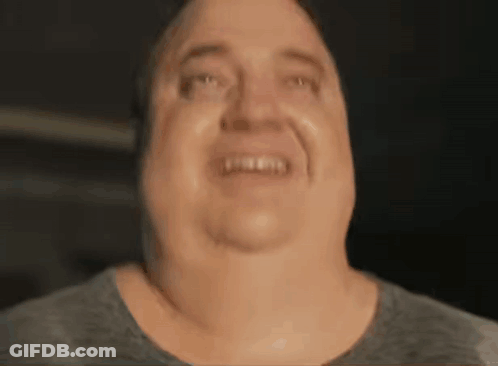 A Close Up Of A Man 'S Face Making A Funny Face And Smiling . GIF