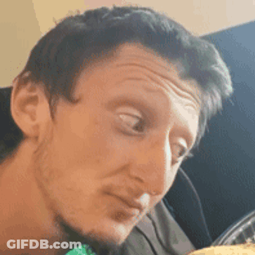 A Close Up Of A Man 'S Face Making A Funny Face While Looking At Something . GIF