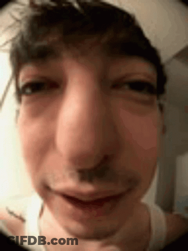 A Close Up Of A Man 'S Face Making A Funny Face With His Eyes Closed . GIF